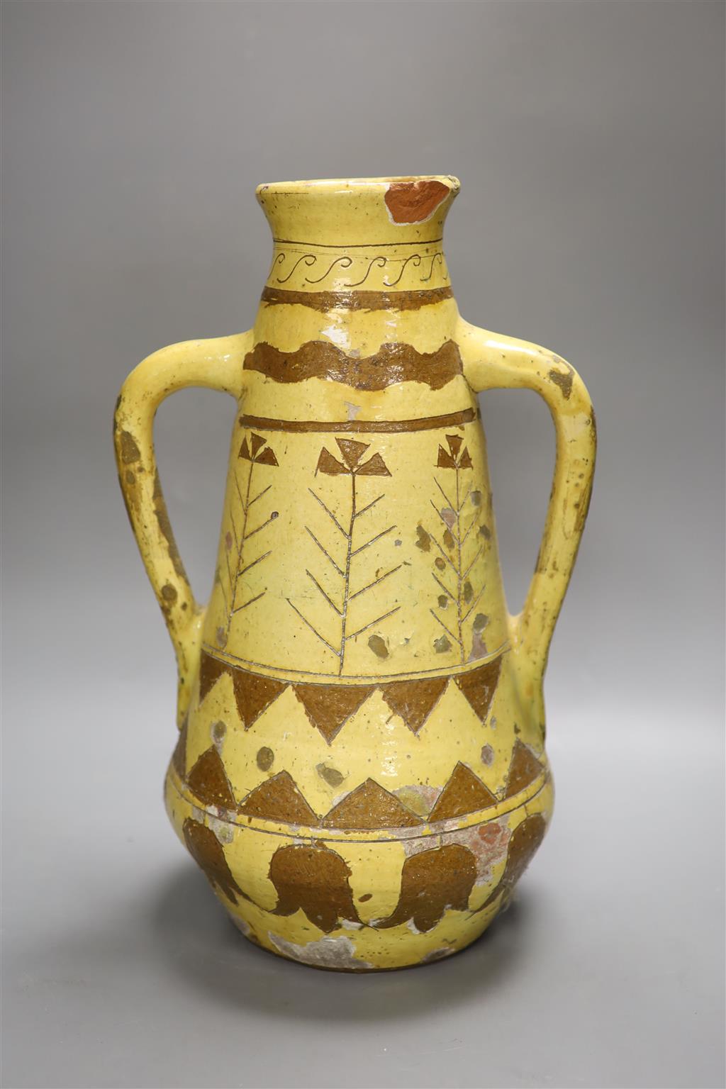 A Continental brown and cream slip decorated two handled vase, height 46cm (a.f.)